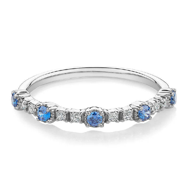 Women’s engraved wedding rings-Wedding or eternity band with blue topaz and diamond simulants in 10 carat white gold