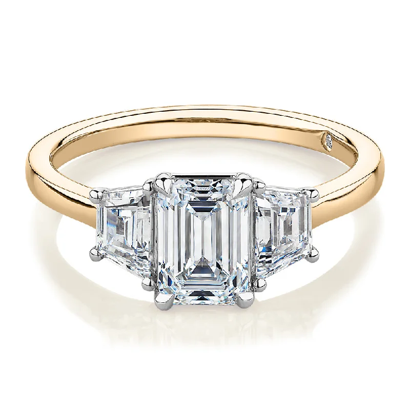 Women’s oval engagement rings-Signature Simulant Diamond 1.87 carat* TW emerald cut three stone ring in 14 carat yellow and white gold