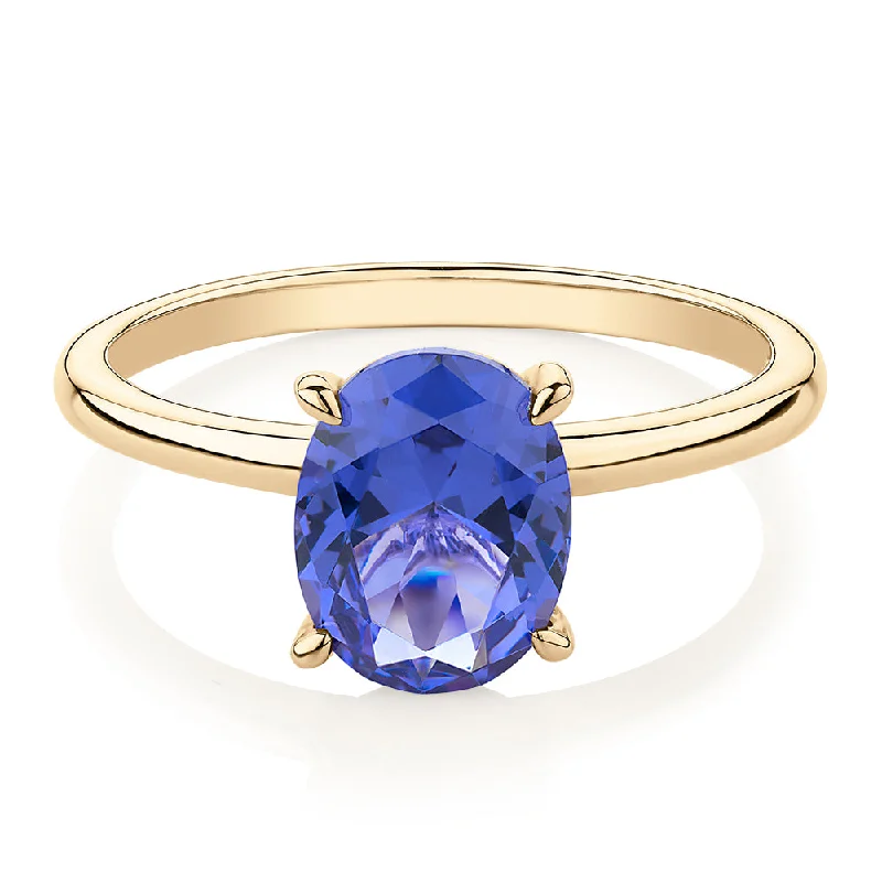 Women’s promise rings for her-Dress ring with tanzanite simulant in 10 carat yellow gold