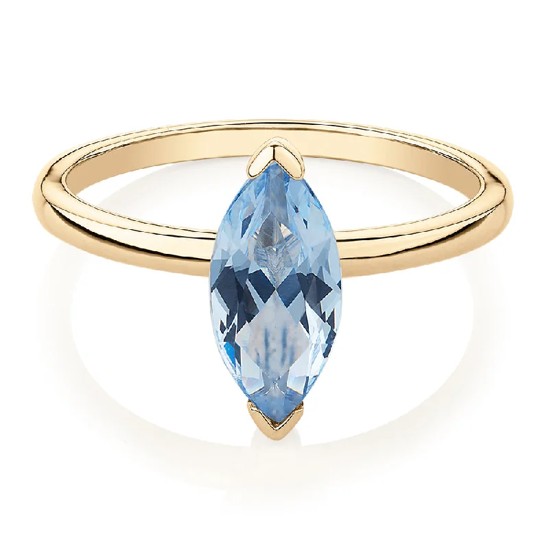 Women’s wedding band sets-Dress ring with aquamarine simulant in 10 carat yellow gold